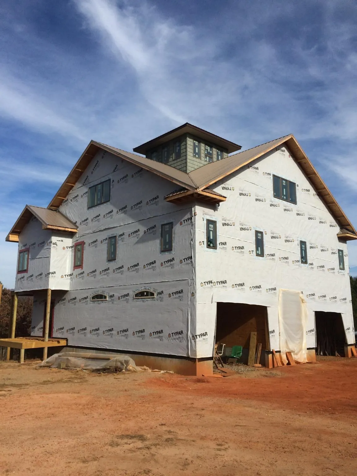 New two story house under construction with a cupola and gabled roofs in Brandamore